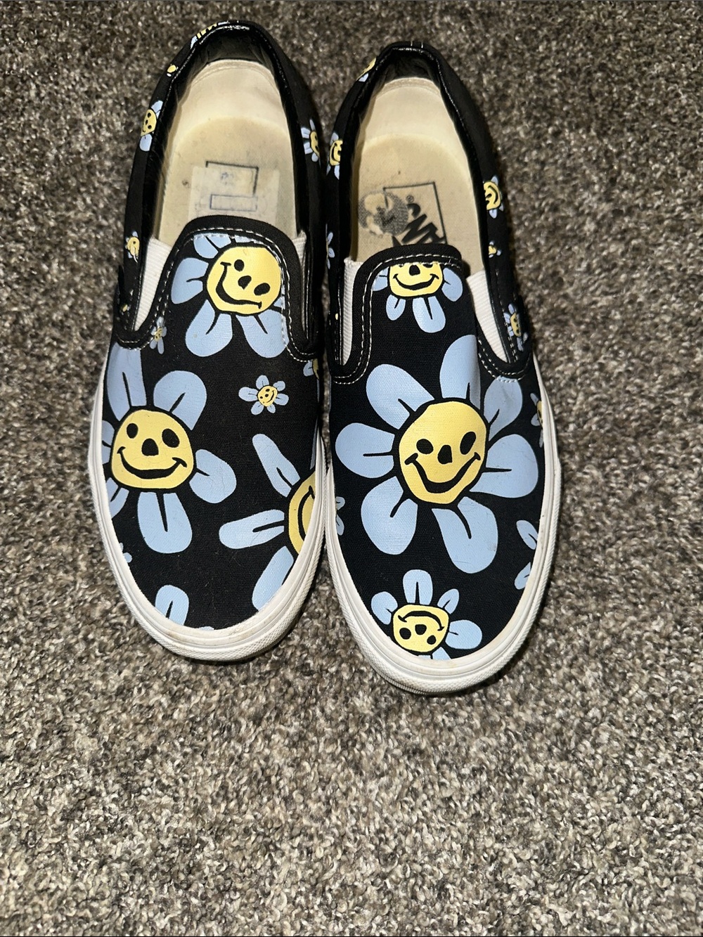 Vans Black Slip-On Sneakers with Yellow & Light Blue Daisy Smiley Print